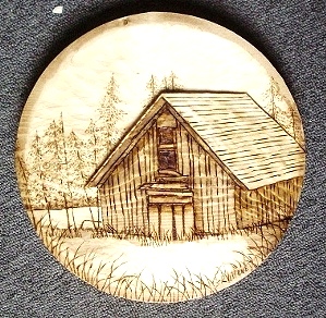 Relief Carving of Cabin by the Lake